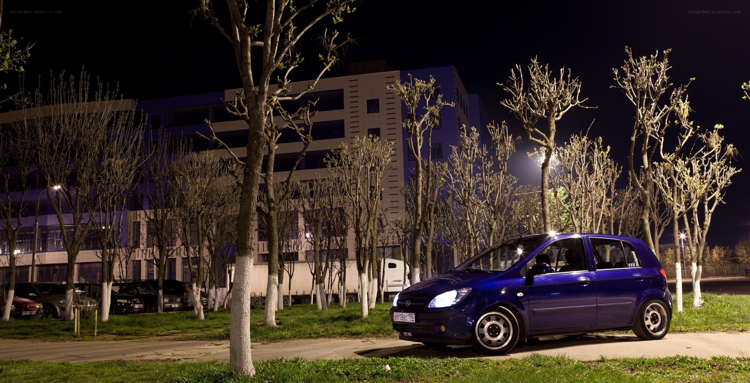 Blue car parked at night