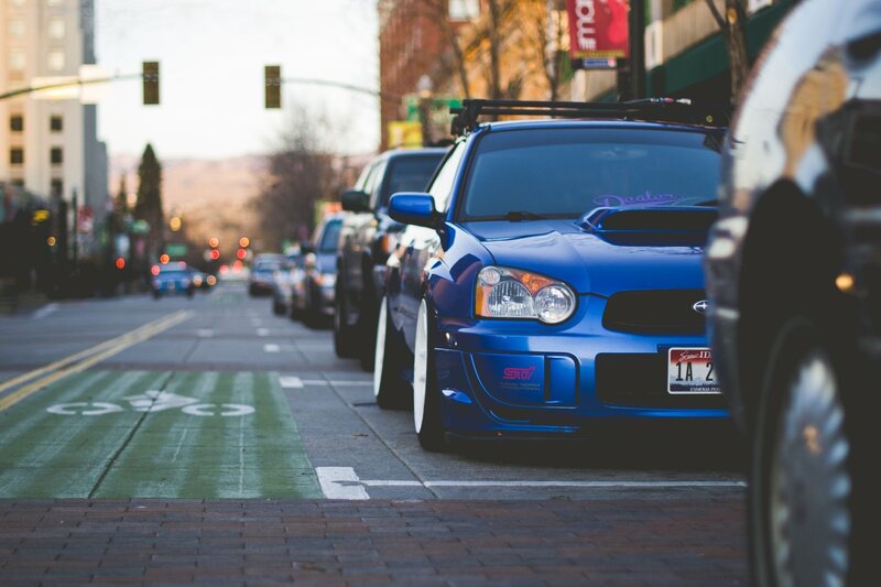 Blue car parked on city street