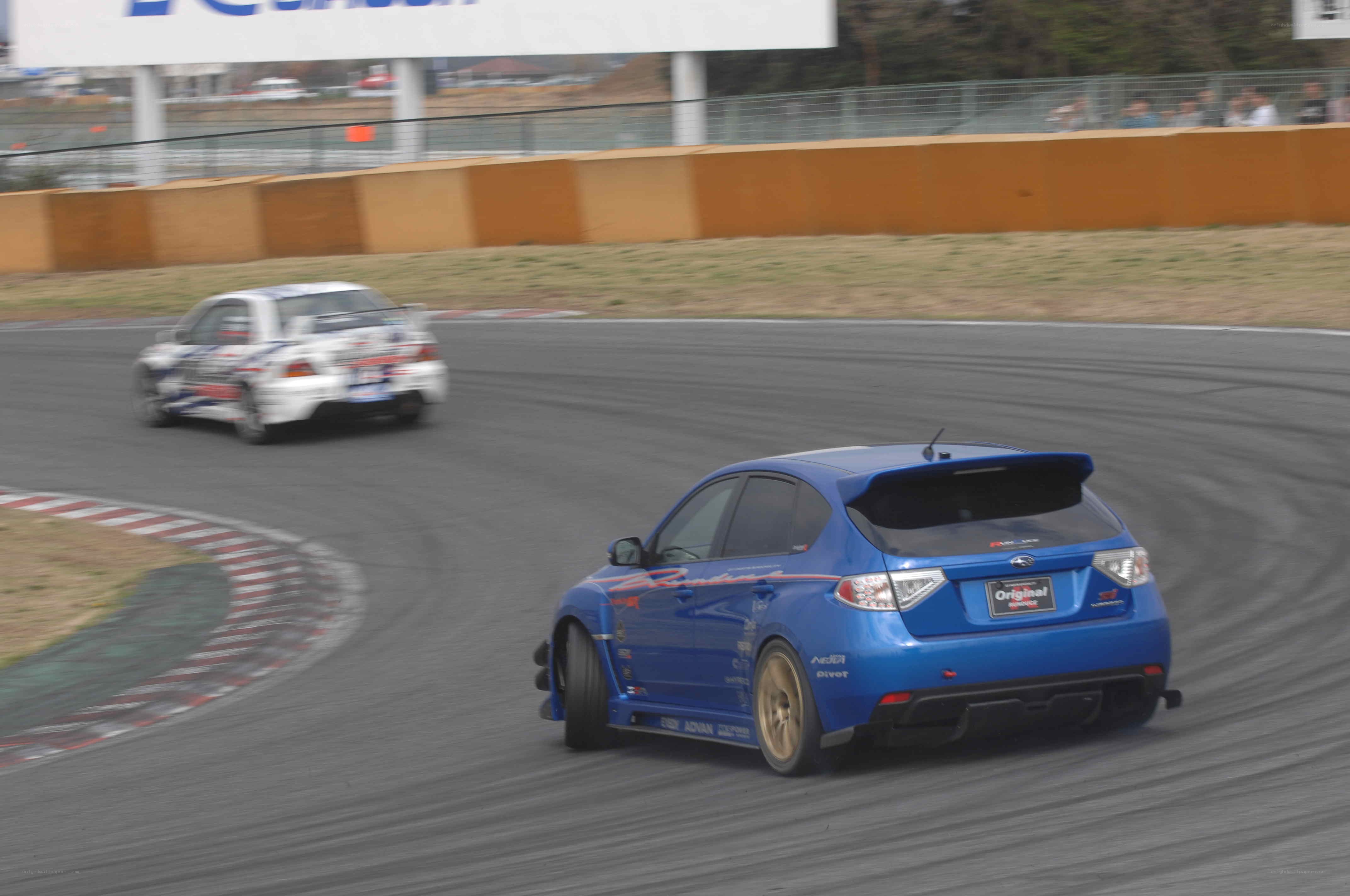 Blue car racing on track