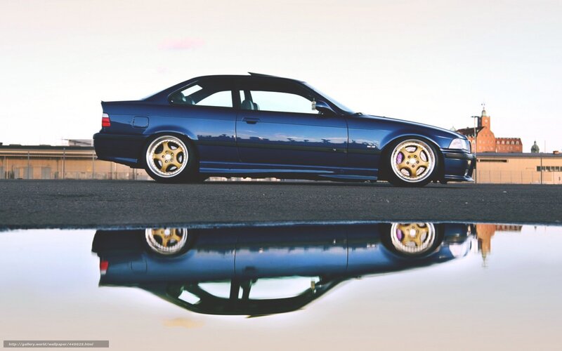 blue car reflection in puddle