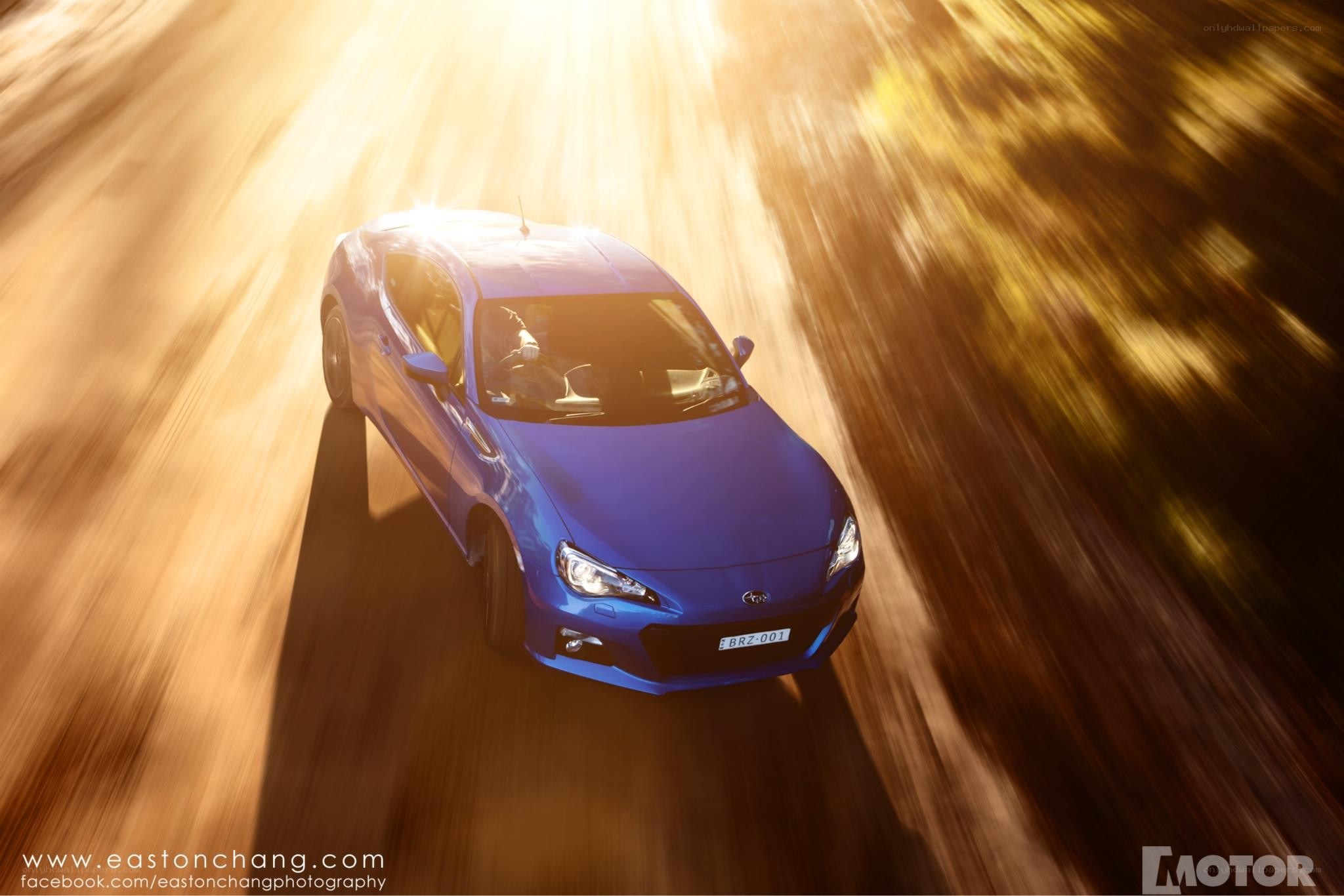 blue car speeding on road