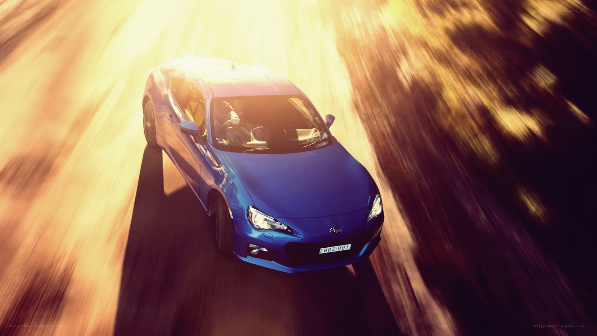 blue car speeding on road