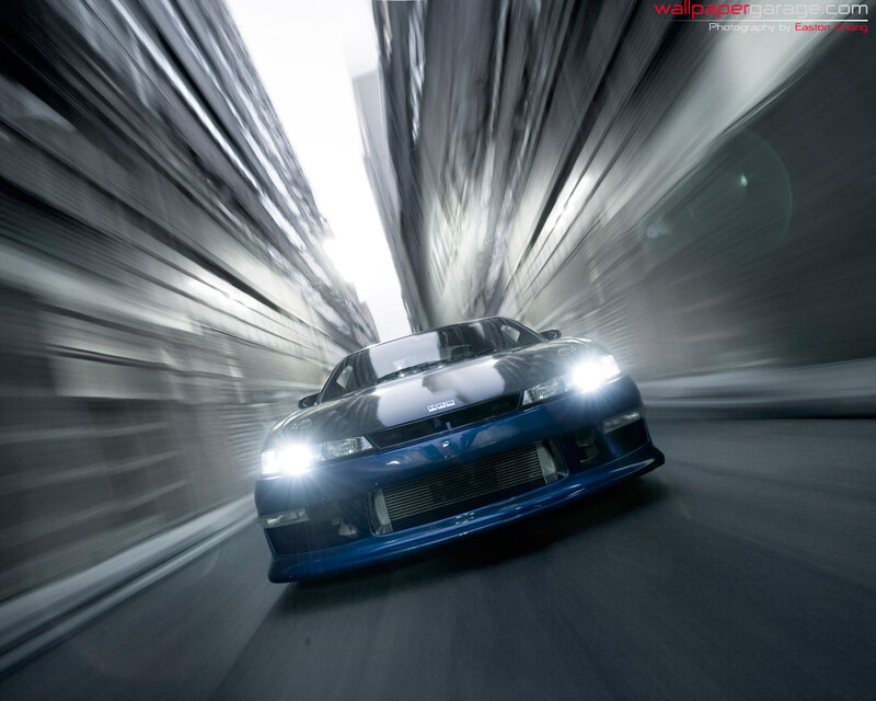blue car speeding through tunnel