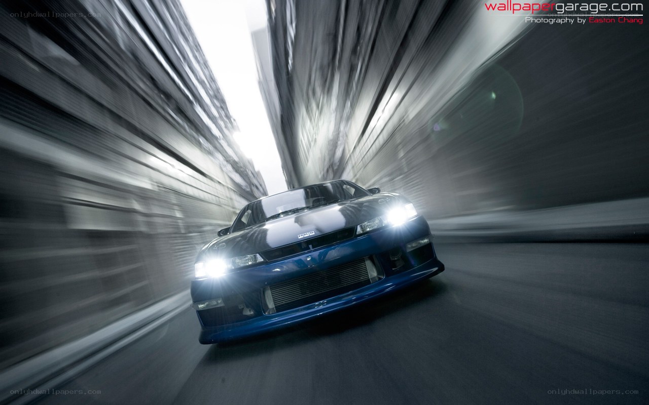blue car speeding through tunnel