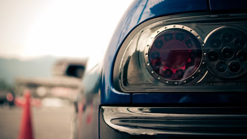 Blue Car Taillight — Dramatic, Afternoon