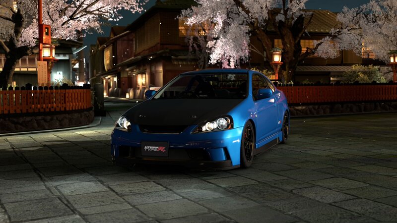 Blue car under cherry blossoms