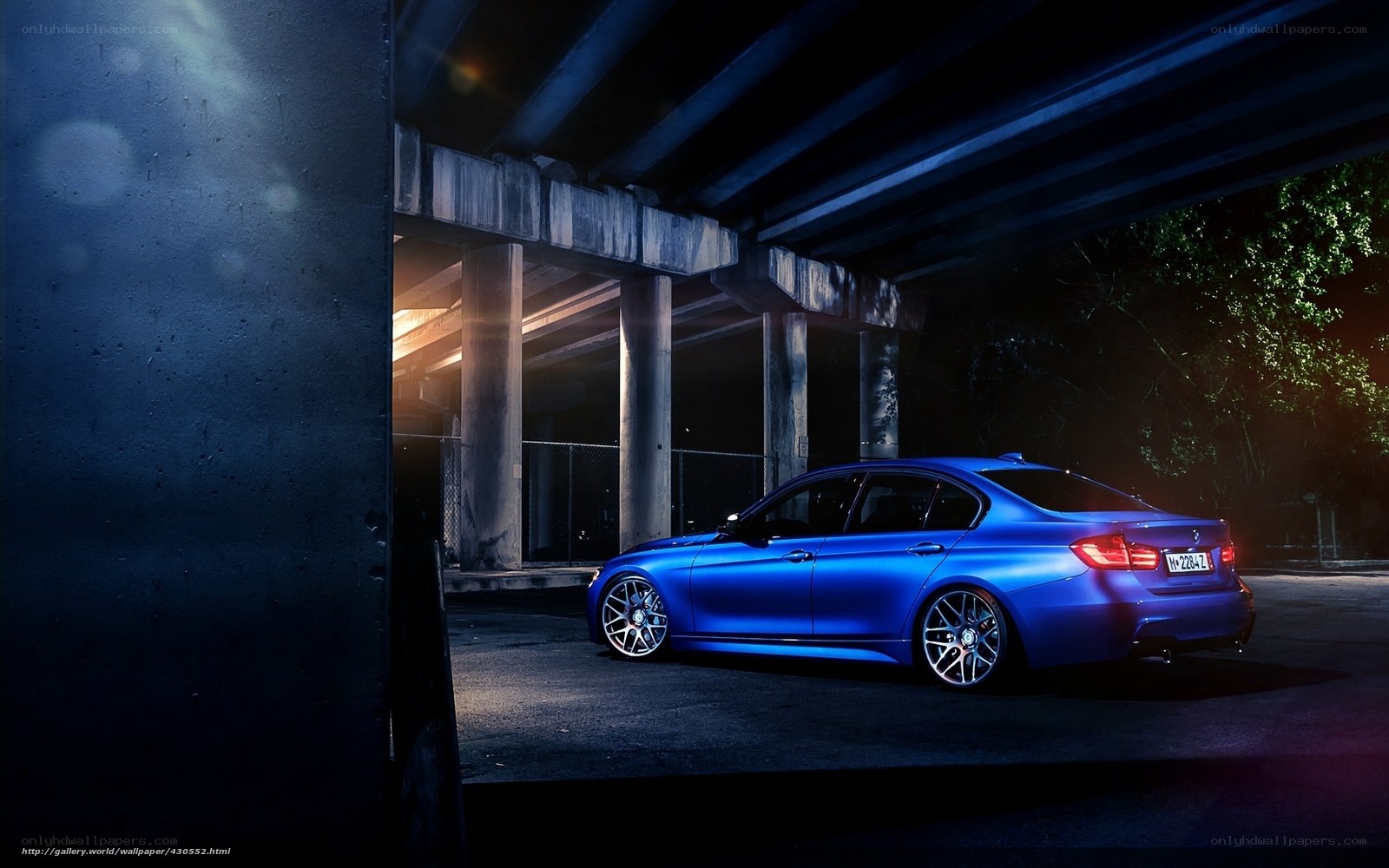 Blue car under overpass