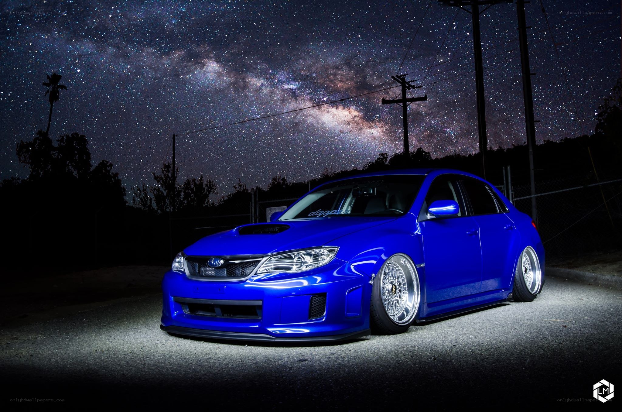 Blue car under starry sky