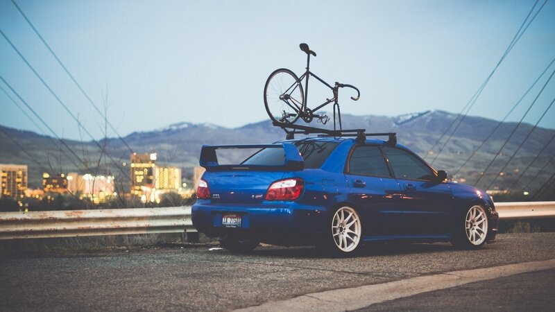 Blue car with bike on roof