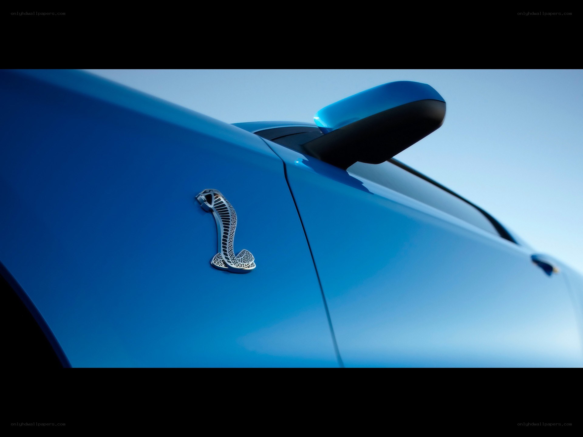 Blue car with cobra emblem