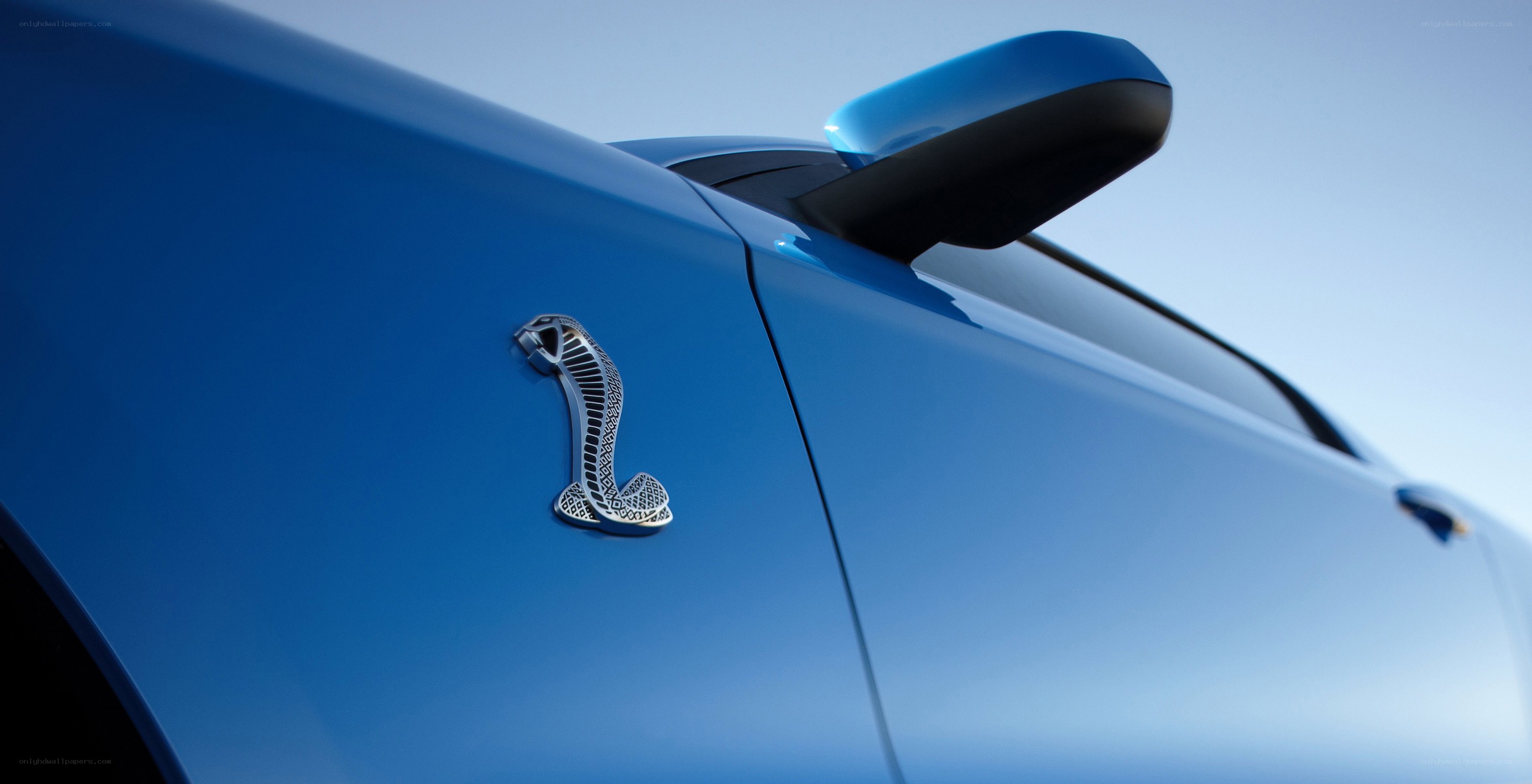 blue car with cobra emblem