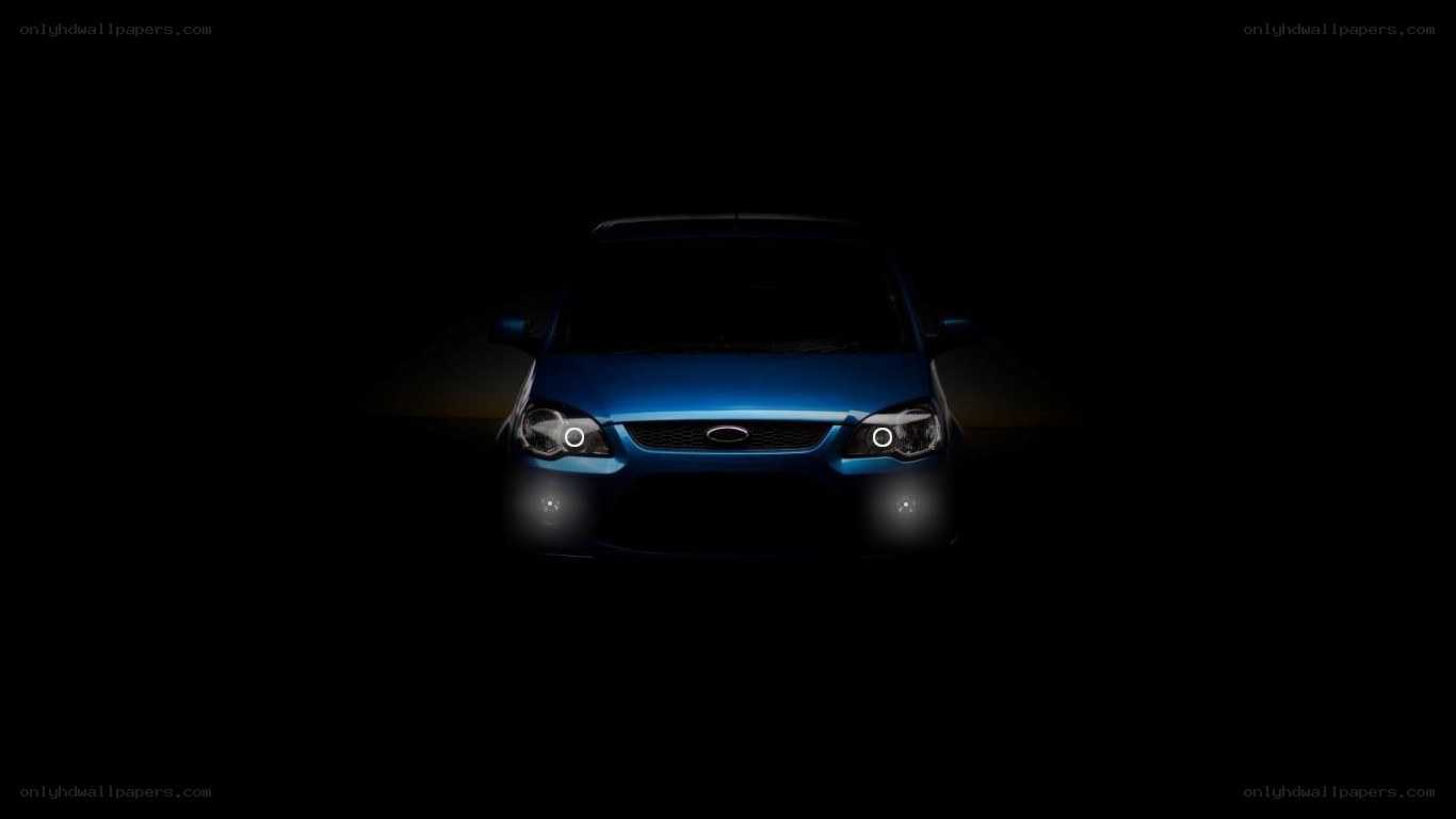 blue car with headlights on