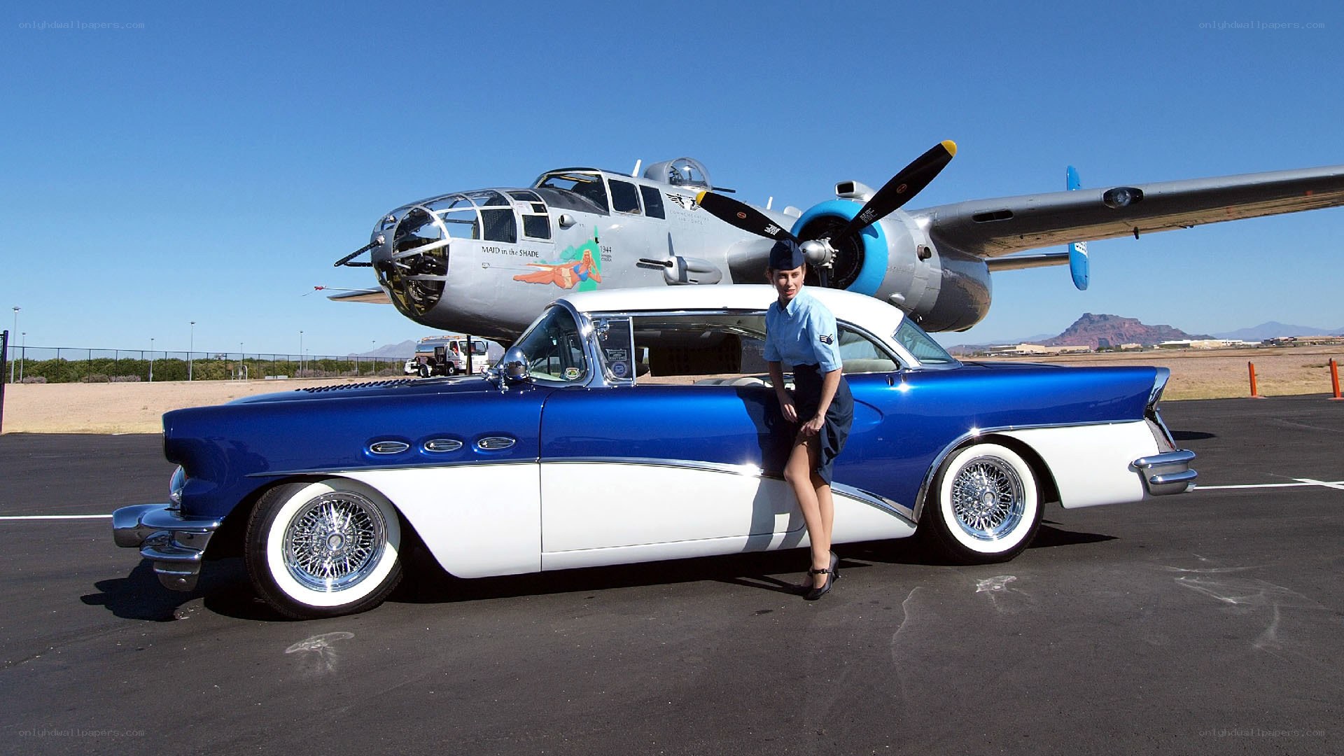 Blue car with vintage plane