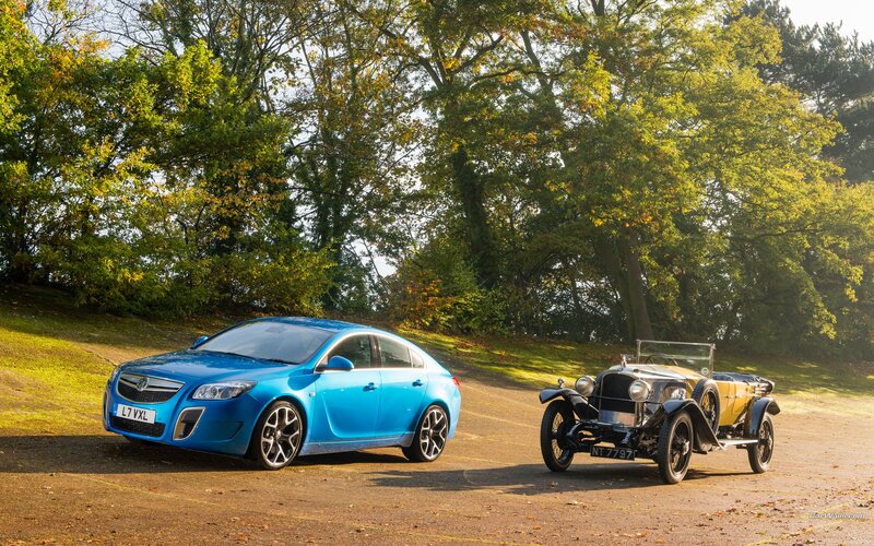 Blue car with vintage vehicle