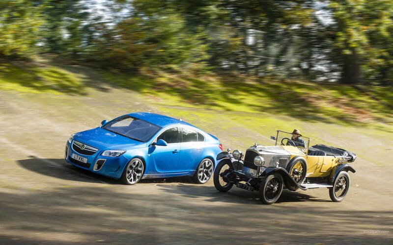 Blue car with vintage vehicle