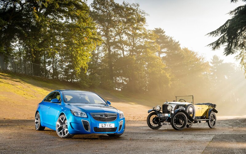 Blue car with vintage vehicle