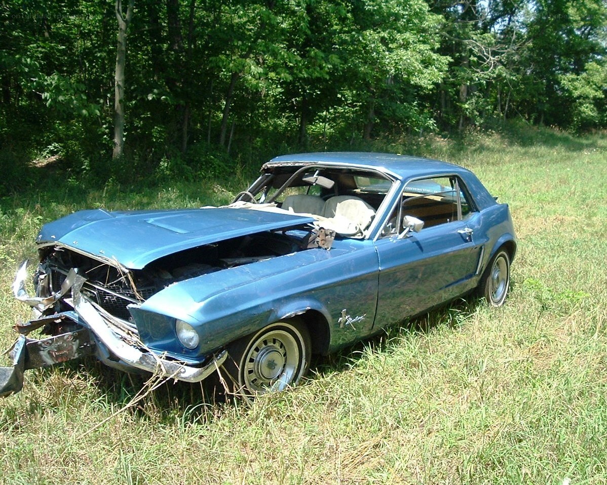 blue car wreck in field