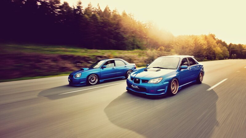 Blue cars racing on road