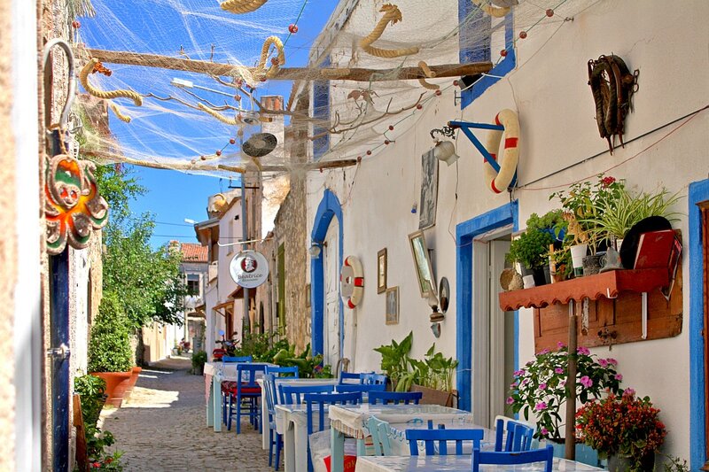 Blue Chairs on Cobblestone Street