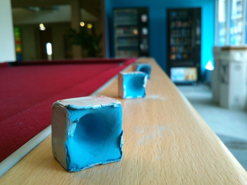 Blue chalk blocks on pool table