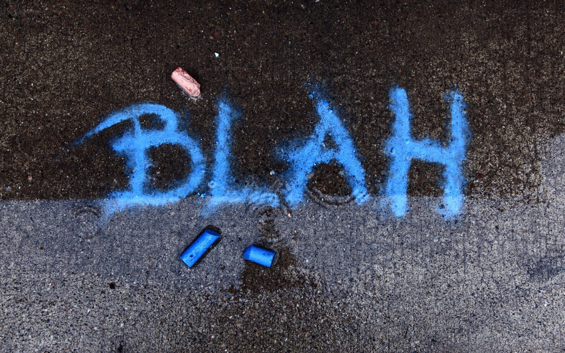 Blue chalk writing on pavement