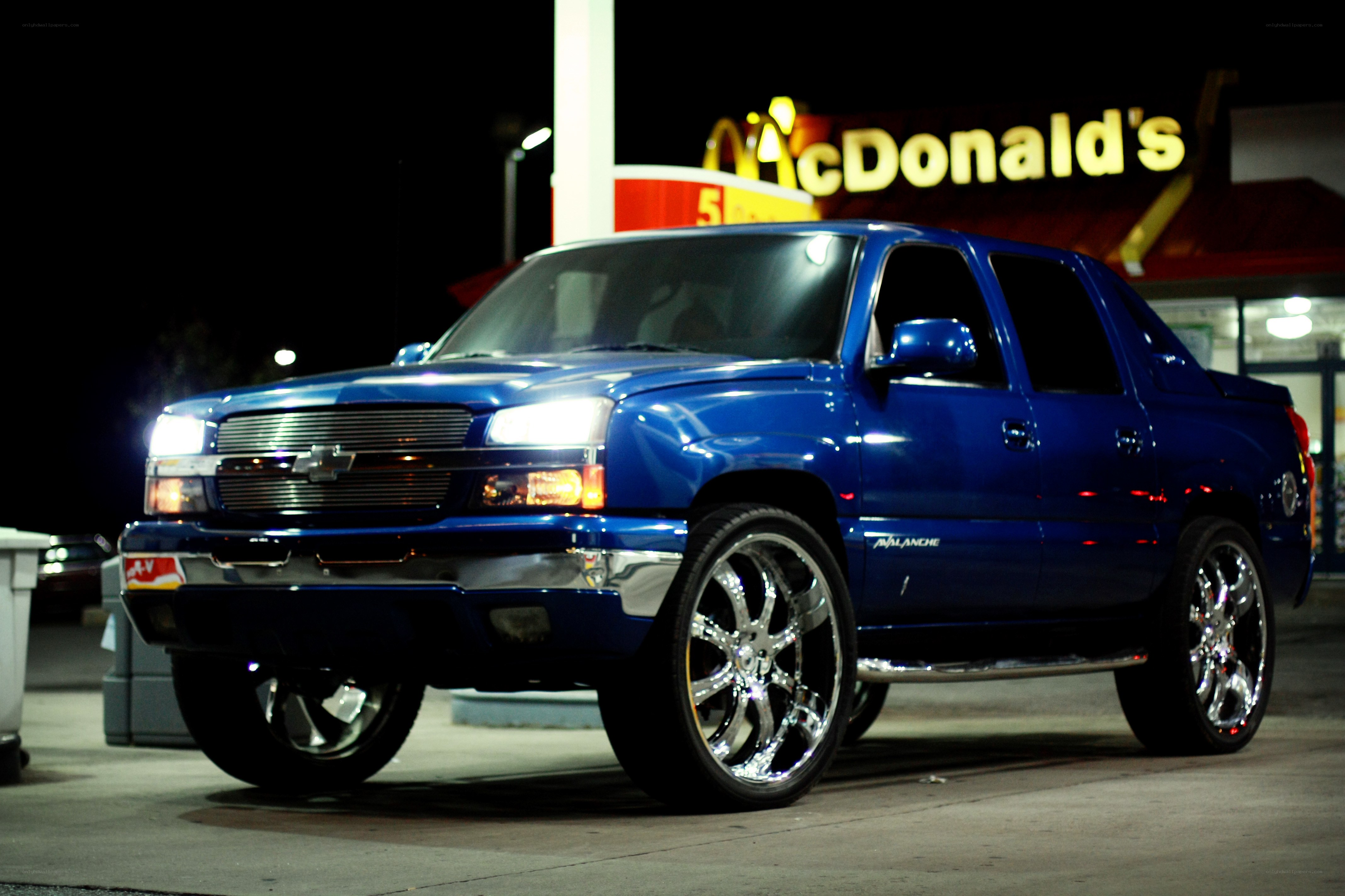 blue chevrolet avalanche at night