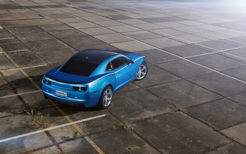 Blue Chevrolet Camaro on concrete