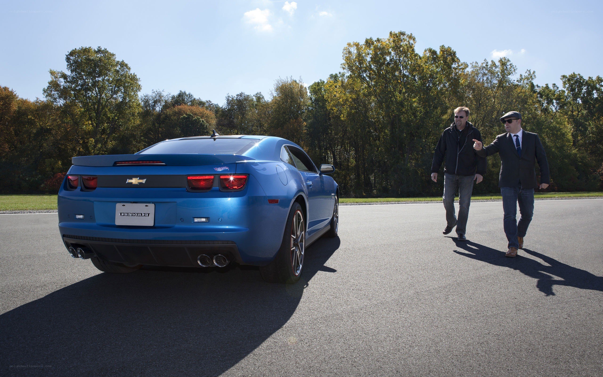 Blue Chevrolet Camaro with two men