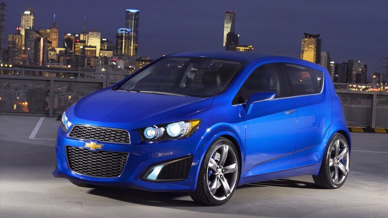 Blue Chevrolet Spark in city
