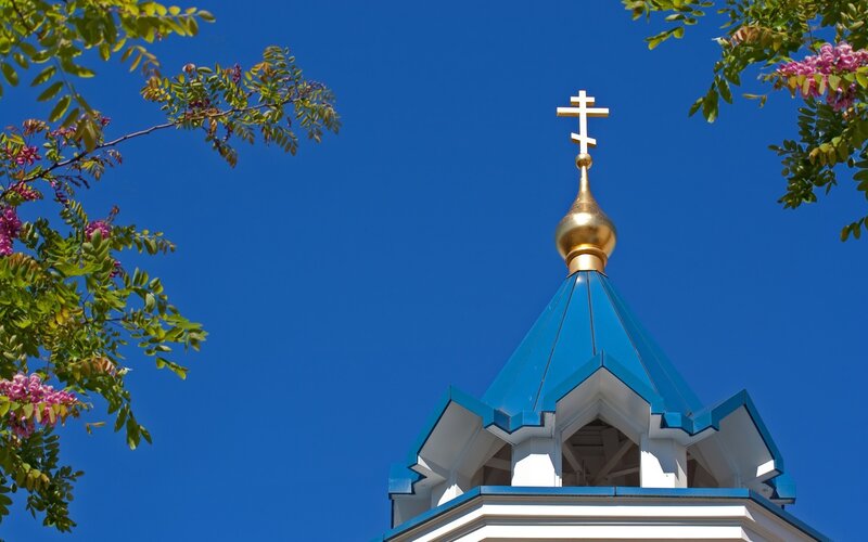 Blue church dome with golden cross