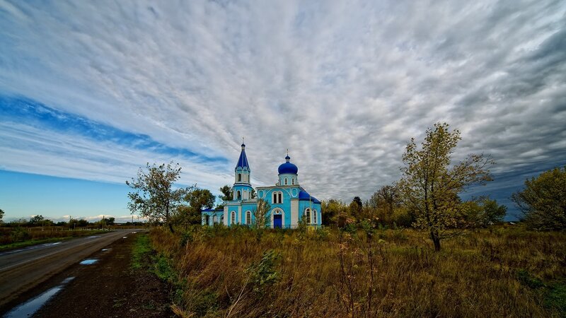 Blue Church in Field — Dramatic