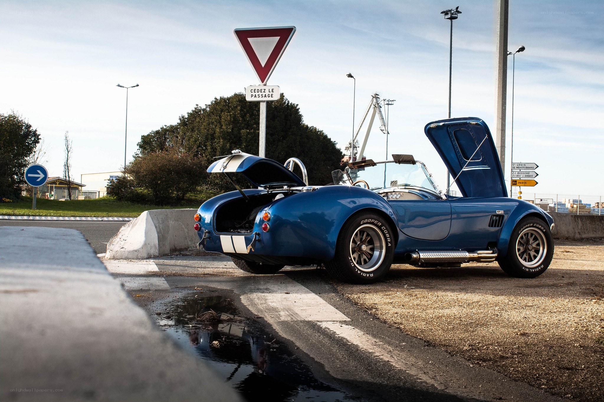 Blue classic car at a crosswalk