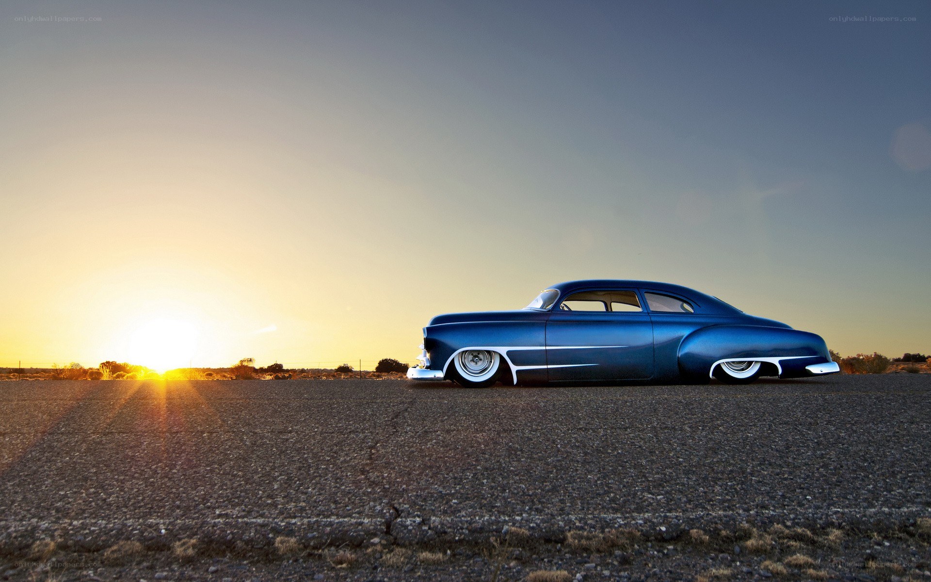 Blue classic car at sunset