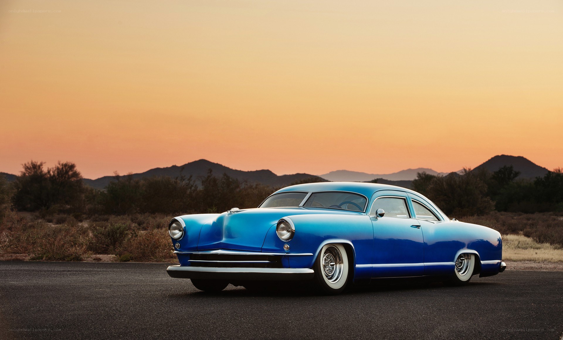 Blue classic car at sunset
