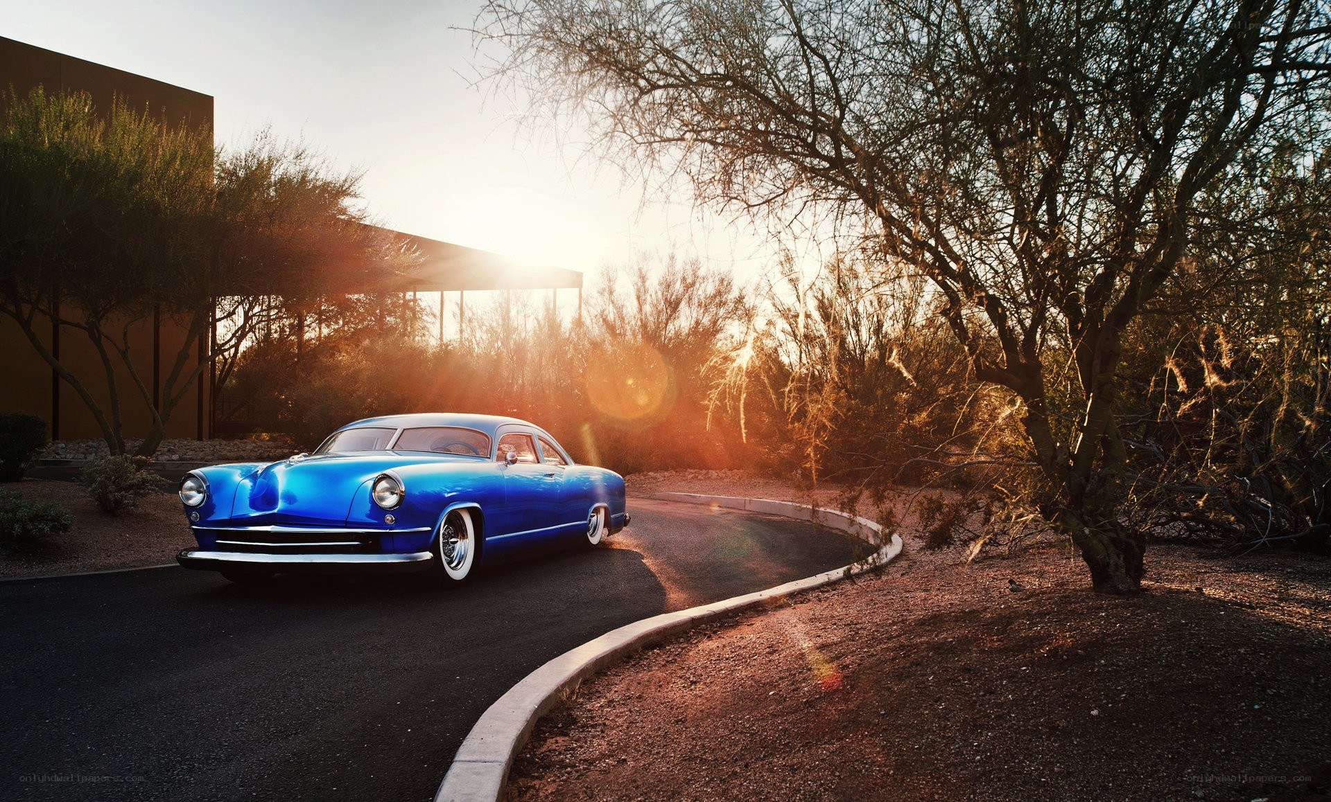 Blue classic car at sunset