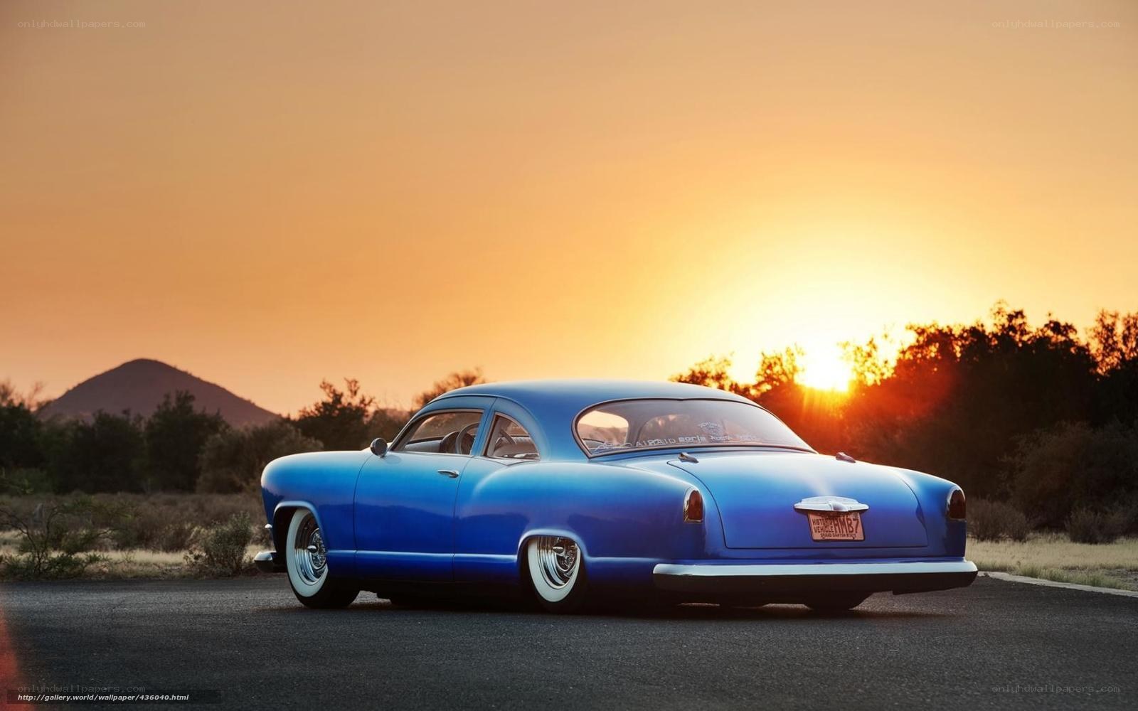 Blue classic car at sunset