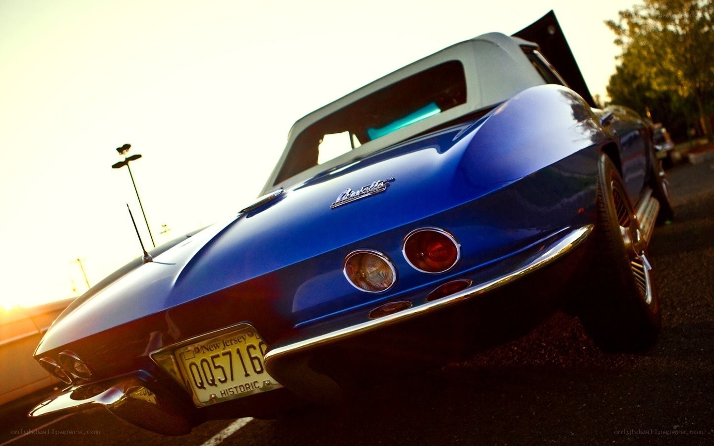 Blue classic car at sunset