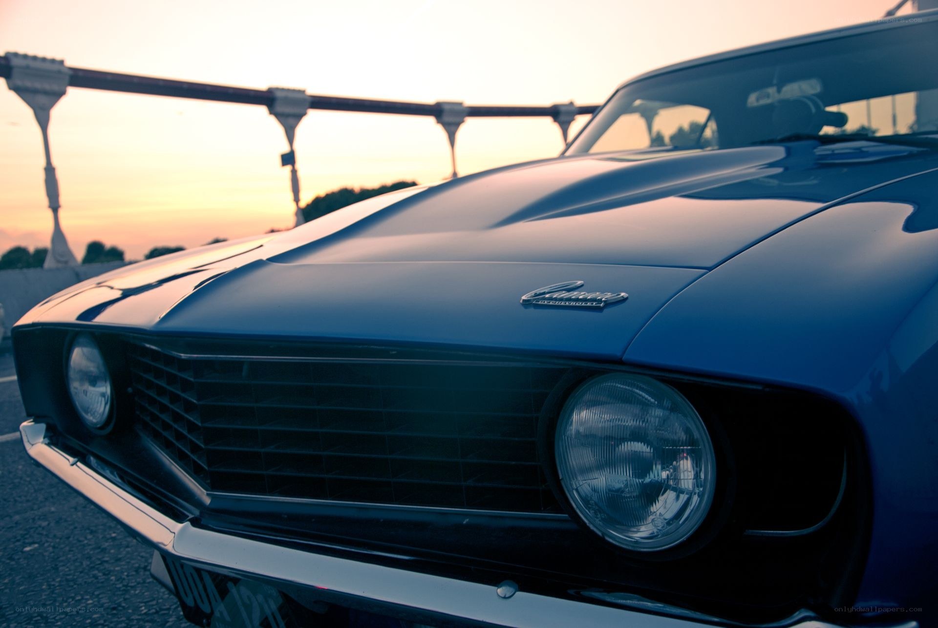 Blue classic car at sunset