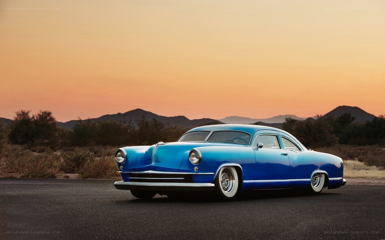 Blue classic car at sunset