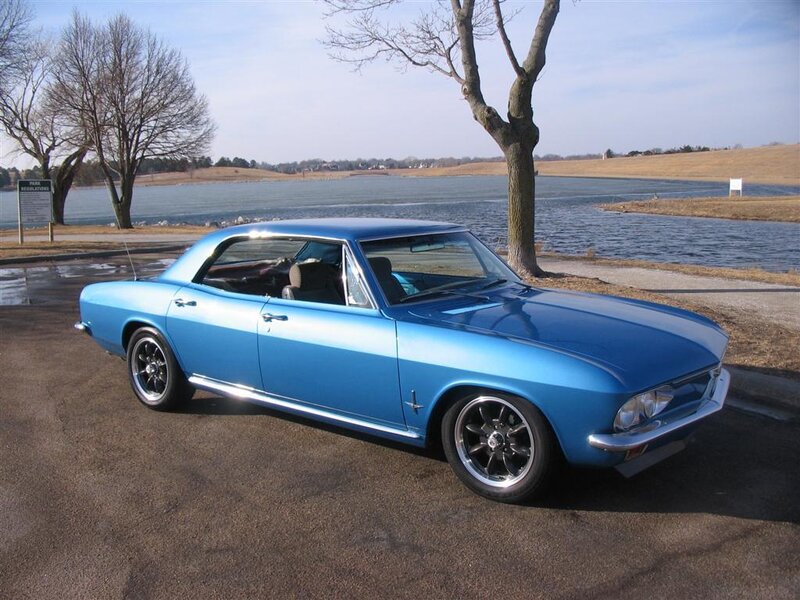 Blue classic car by the lake