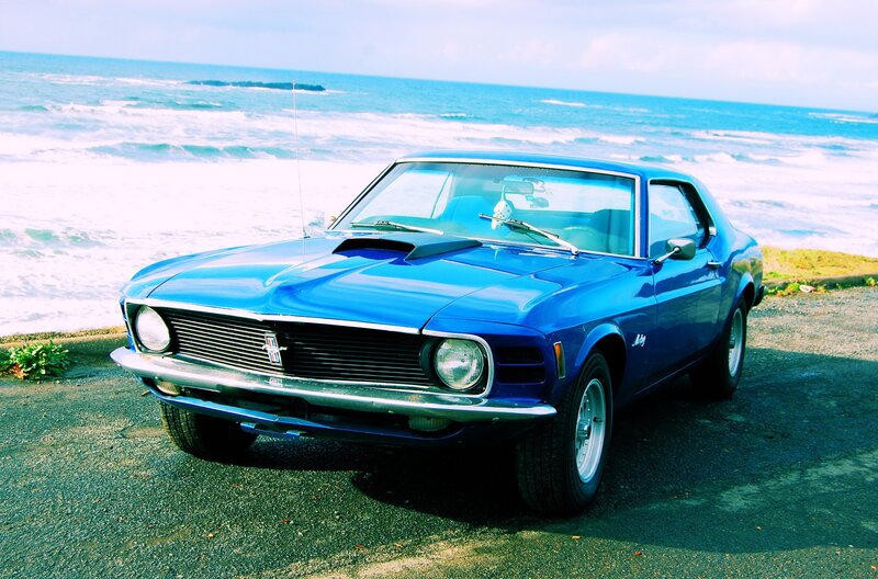 Blue classic car by the ocean