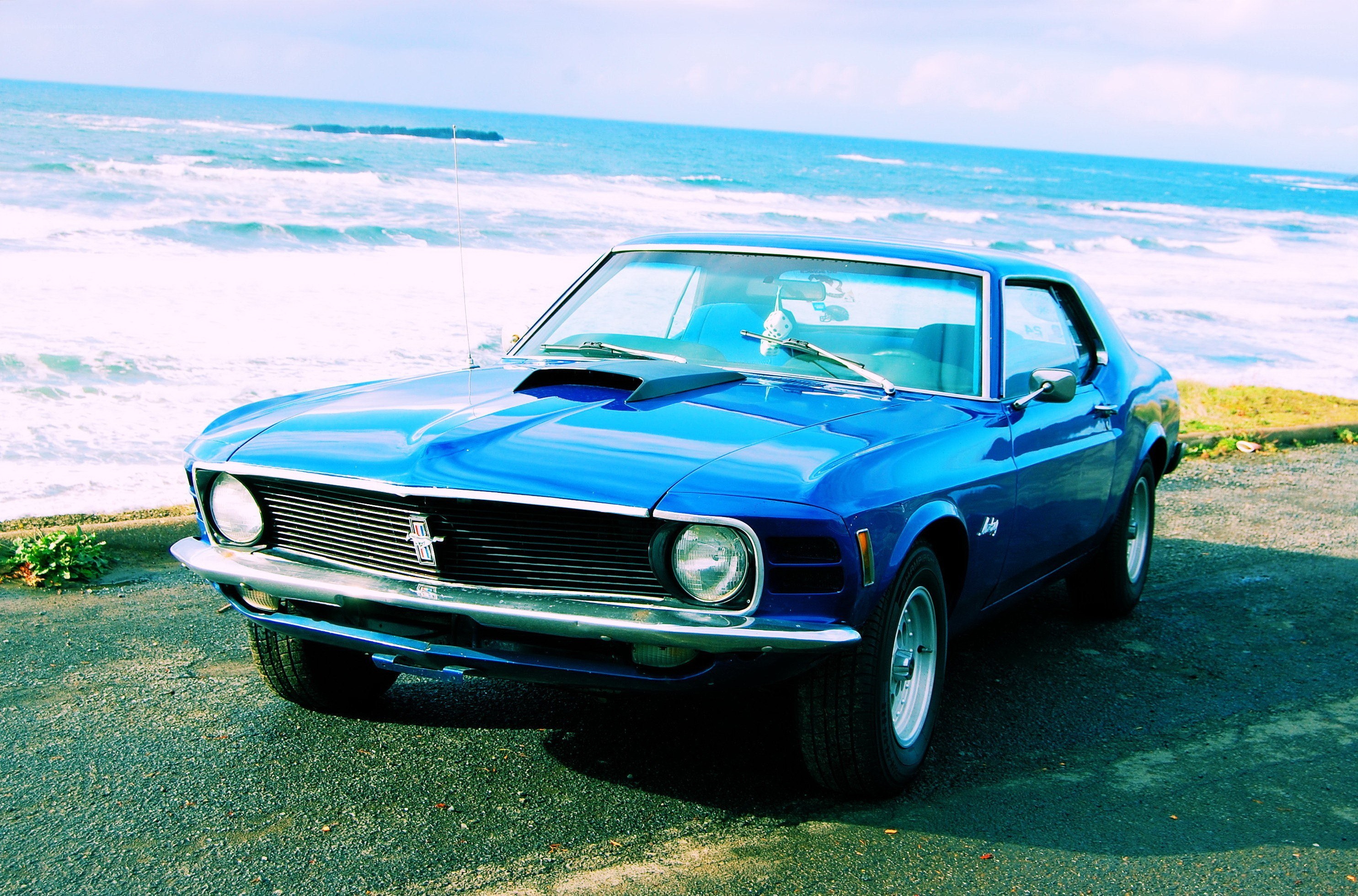 Blue classic car by the ocean
