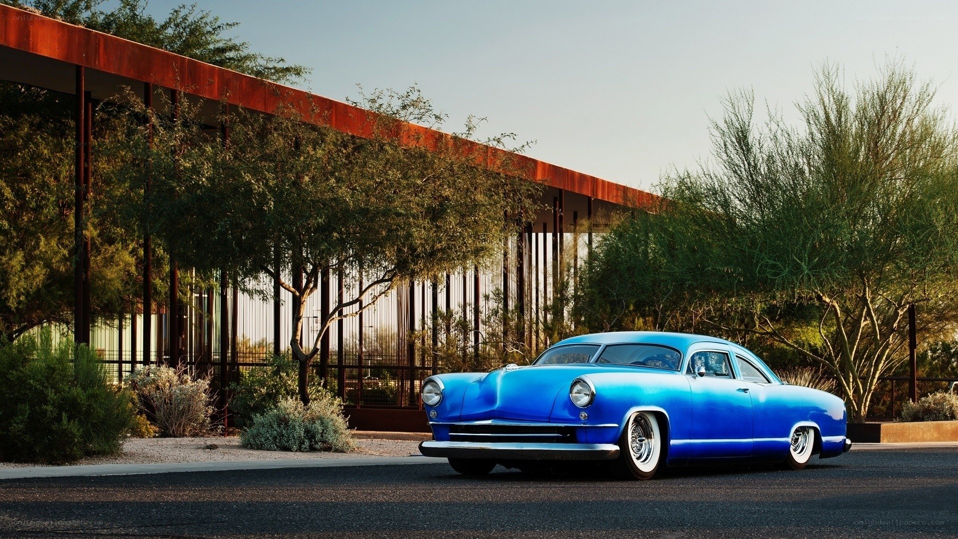 Blue classic car in desert setting