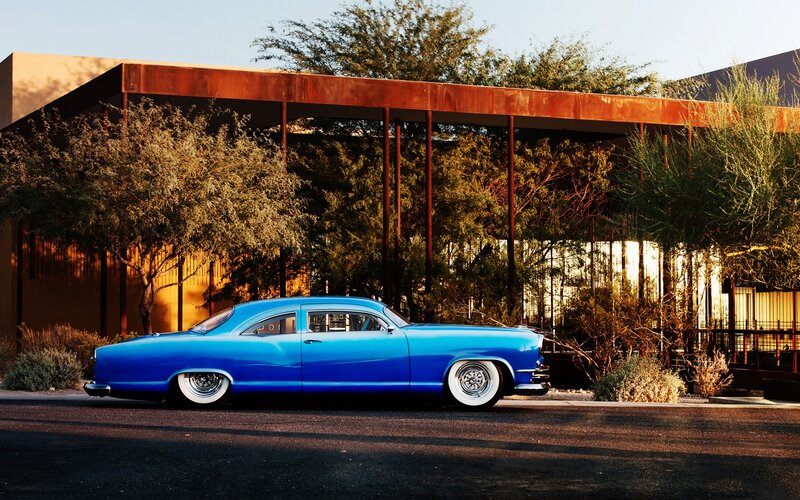 Blue classic car in desert setting