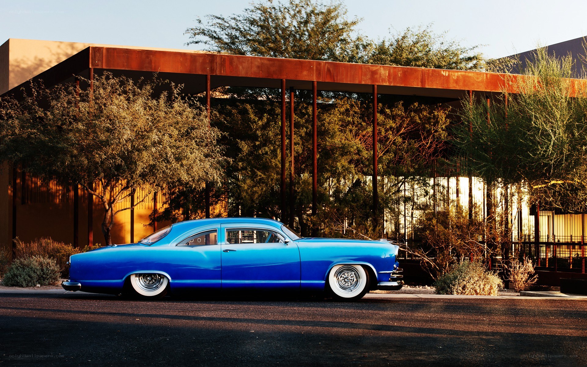 Blue classic car in desert setting