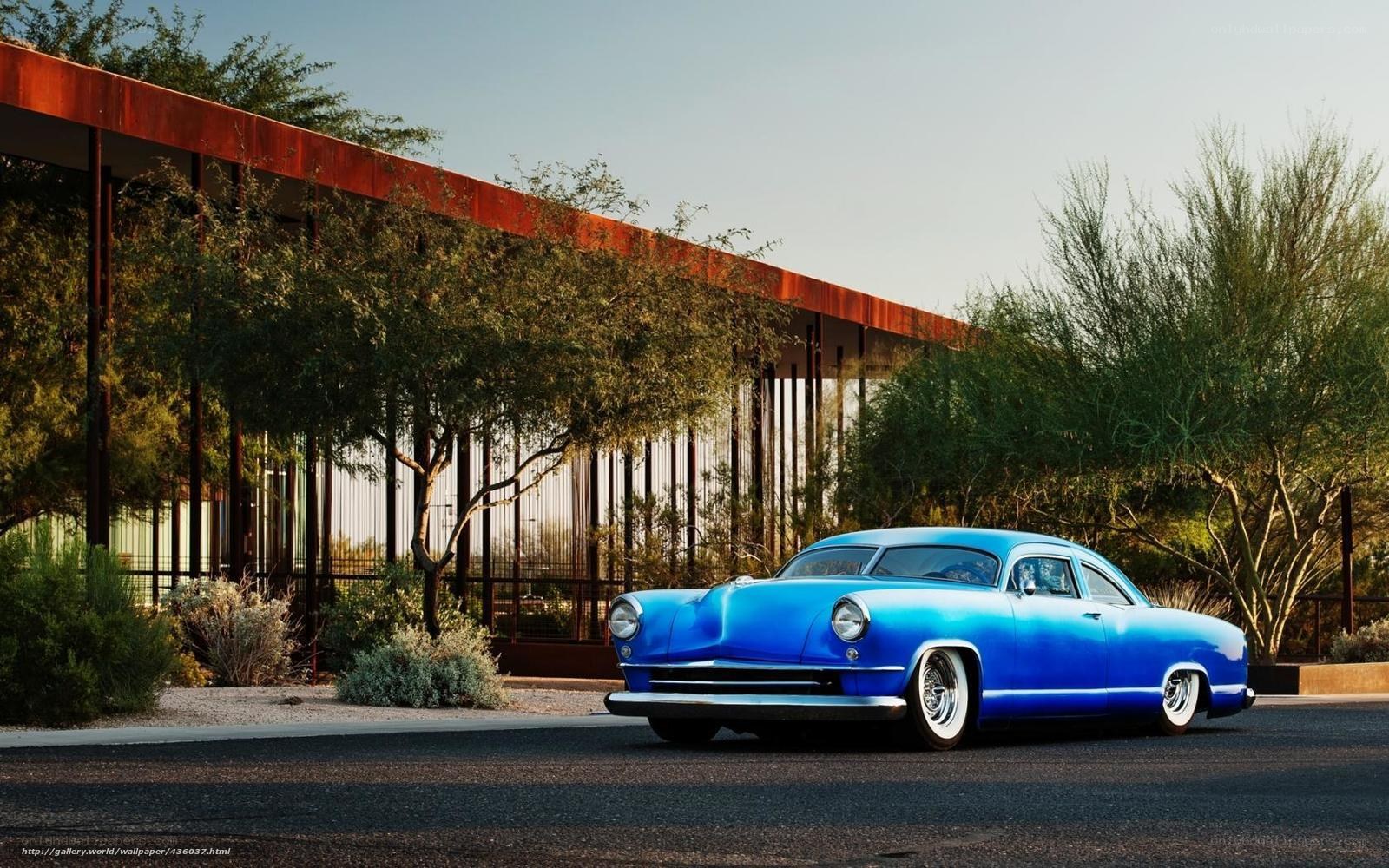Blue classic car in desert setting