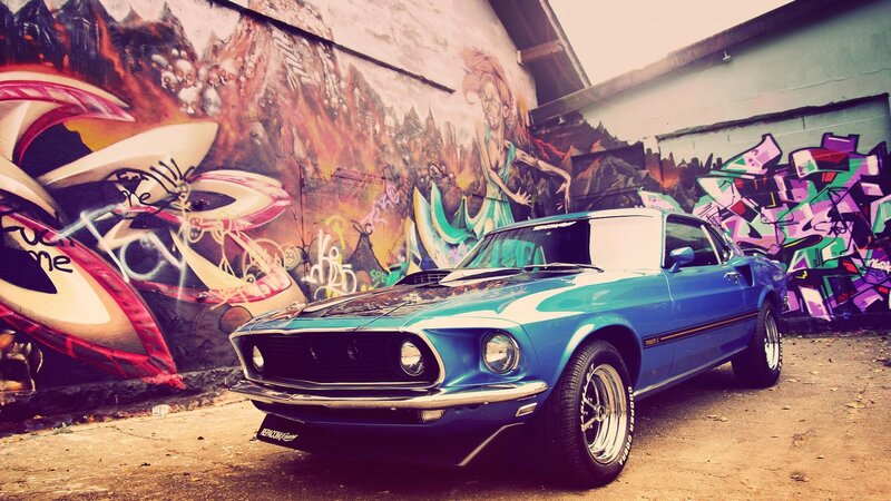 Blue classic car in graffiti alley