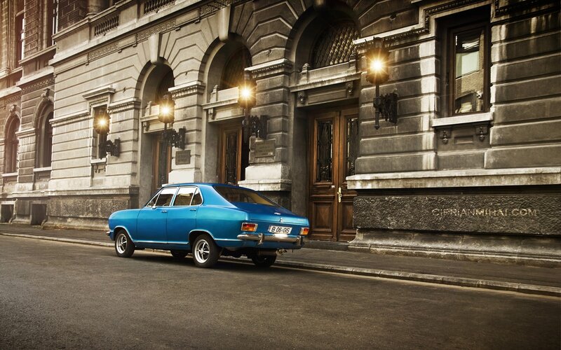Blue classic car on city street