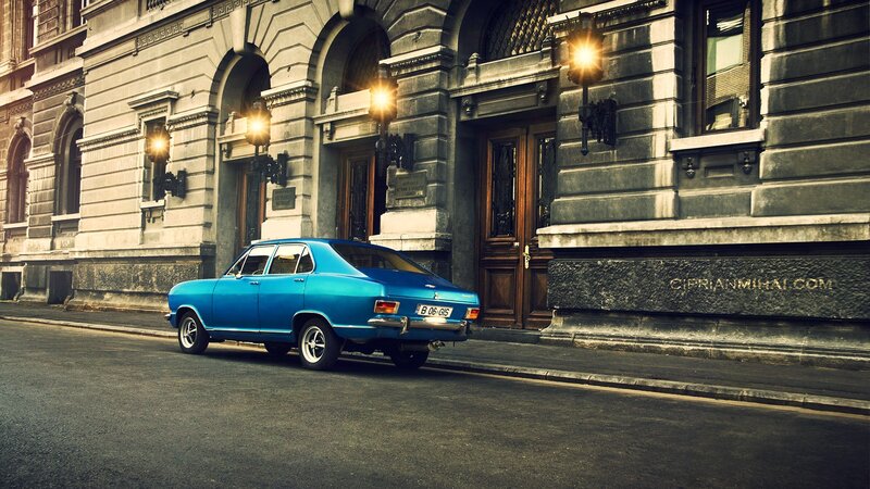 Blue classic car on city street