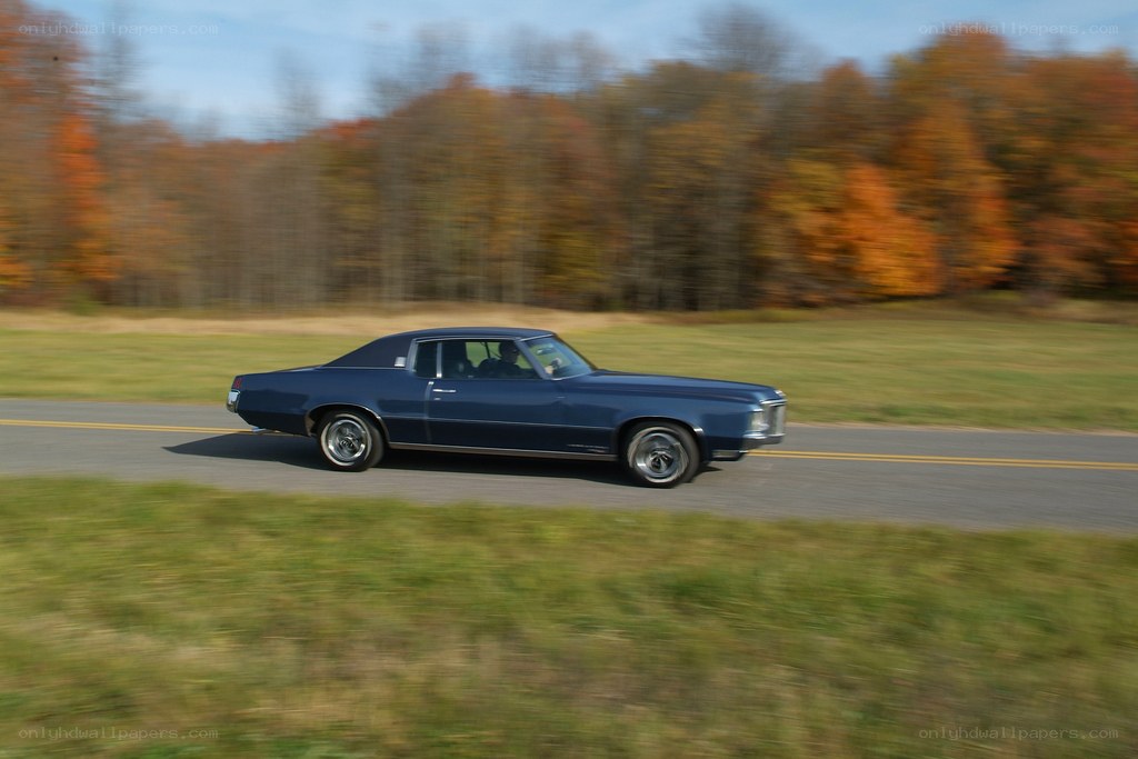 blue classic car on road